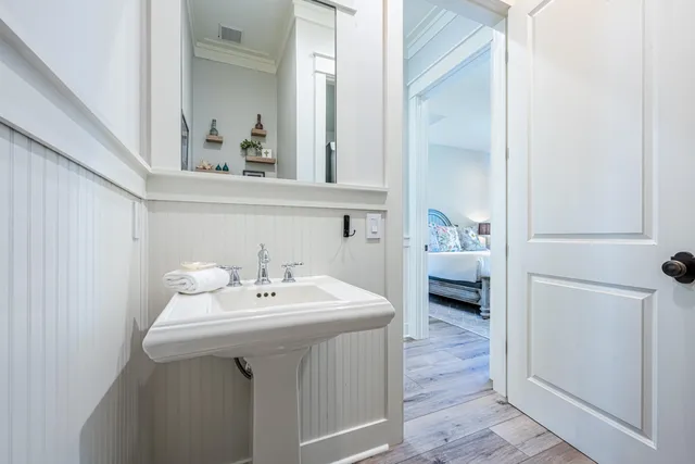 a bathroom with a sink a toilet and mirror
