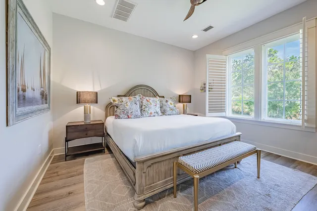 a bedroom with a bed and a large window