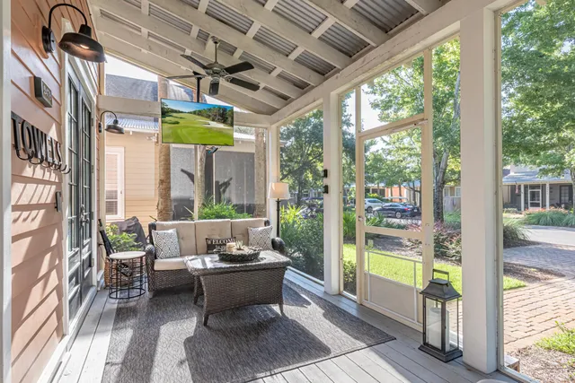 a living room with furniture and a floor to ceiling window