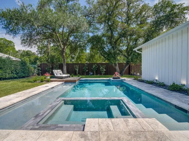 a view of a backyard with swimming pool