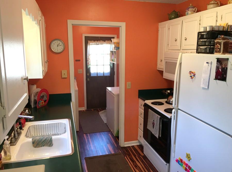 1008 Jacksons Valley Road Hermitage, TN 37076 - Photo 8 of 22 a kitchen with stainless steel appliances a stove a refrigerator a oven a sink with wooden floor and cabinets