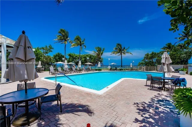 a living room with patio furniture and a flat screen tv