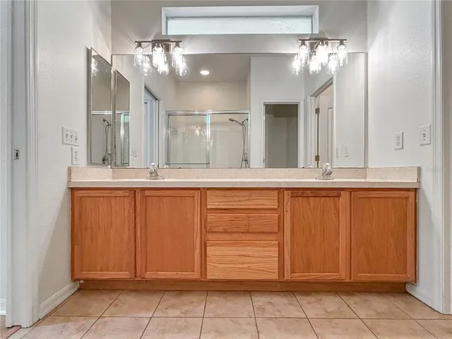 a bathroom with a glass shower door