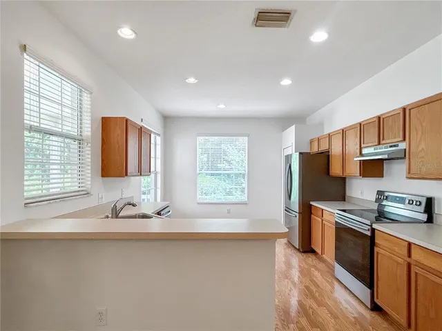 a kitchen with granite countertop cabinets sink and microwave