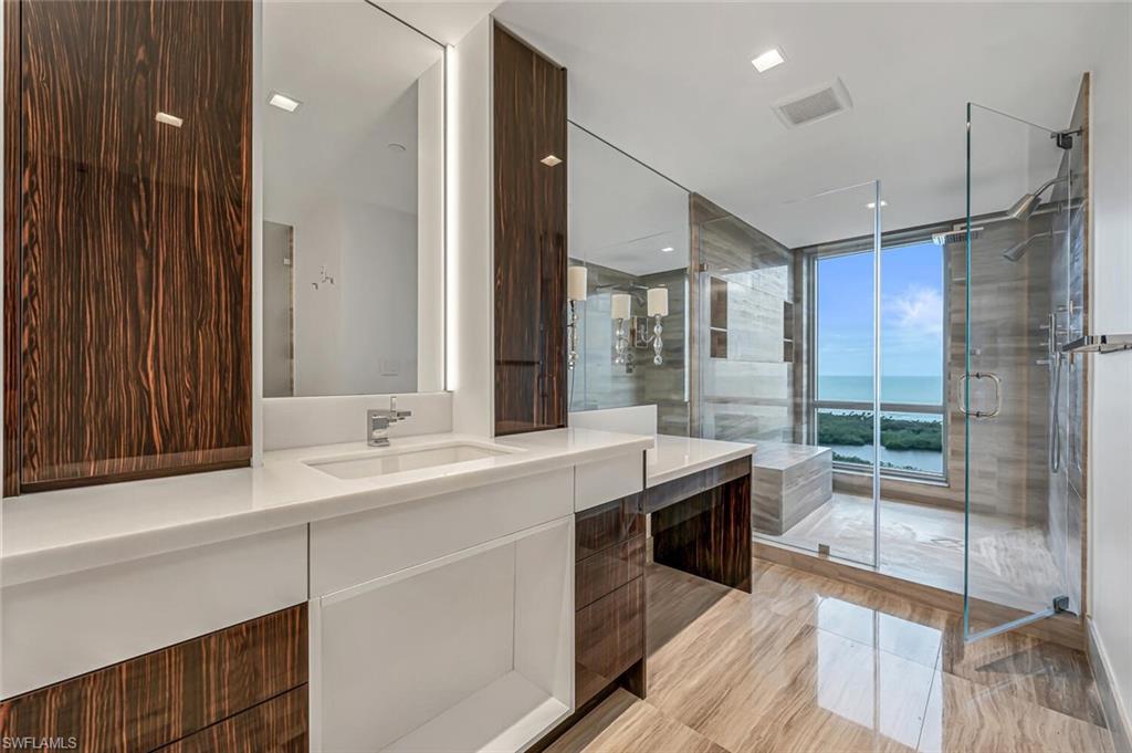 6897 Grenadier Boulevard, Unit 1804 Naples, FL 34108 - Photo 21 of 30 a large kitchen with a sink and stainless steel appliances