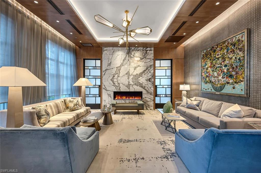 6897 Grenadier Boulevard, Unit 1804 Naples, FL 34108 - Photo 26 of 30 a living room with furniture and a fireplace