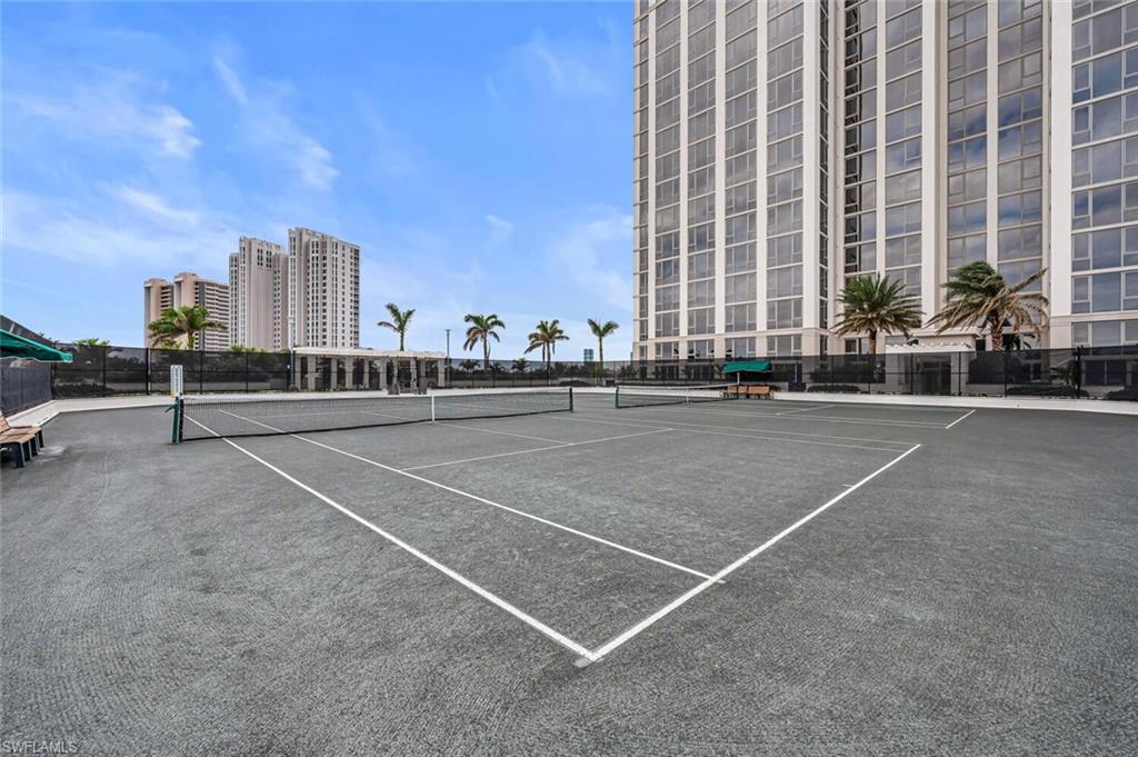 6897 Grenadier Boulevard, Unit 1804 Naples, FL 34108 - Photo 29 of 30 a view of a tall building next to a road