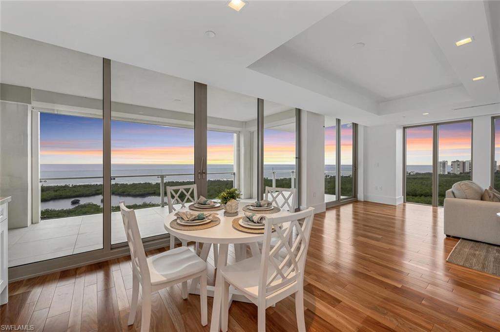 6897 Grenadier Boulevard, Unit 1804 Naples, FL 34108 - Photo 6 of 30 a view of a dining room with furniture window and wooden floor