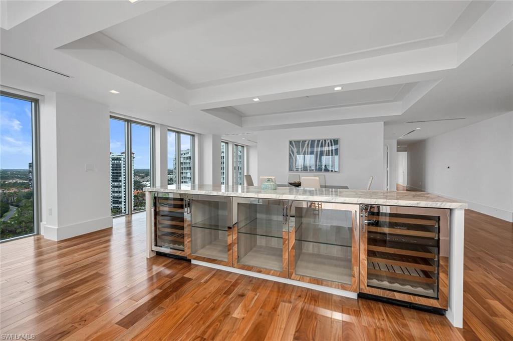 6897 Grenadier Boulevard, Unit 1804 Naples, FL 34108 - Photo 9 of 30 a view of kitchen and wooden floor