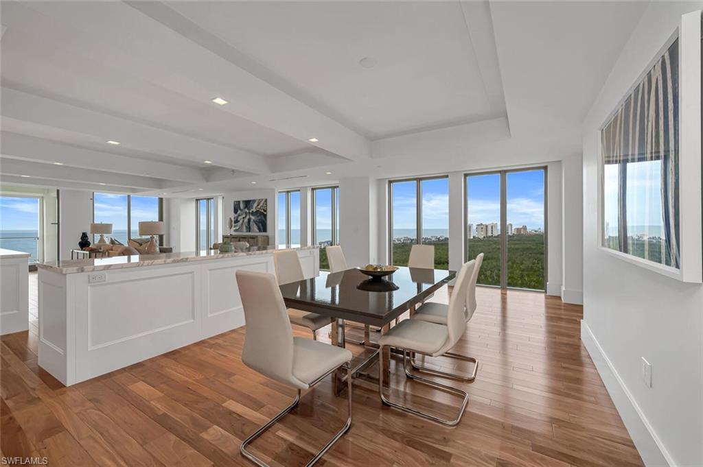 6897 Grenadier Boulevard, Unit 1804 Naples, FL 34108 - Photo 10 of 30 a view of a dining room with furniture window and wooden floor