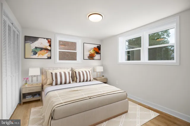 a bedroom with a bed and a painting on the wall