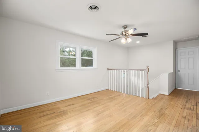 a view of a room with a ceiling fan and a window