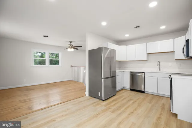 a kitchen with a refrigerator and a sink