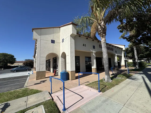 a view of a white house with a yard