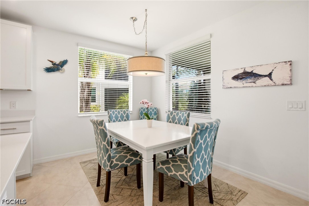 3751 Pebblebrook Ridge Court, Unit 101 Fort Myers, FL 33905 - Photo 15 of 48 a view of a dining room with furniture window and wooden floor