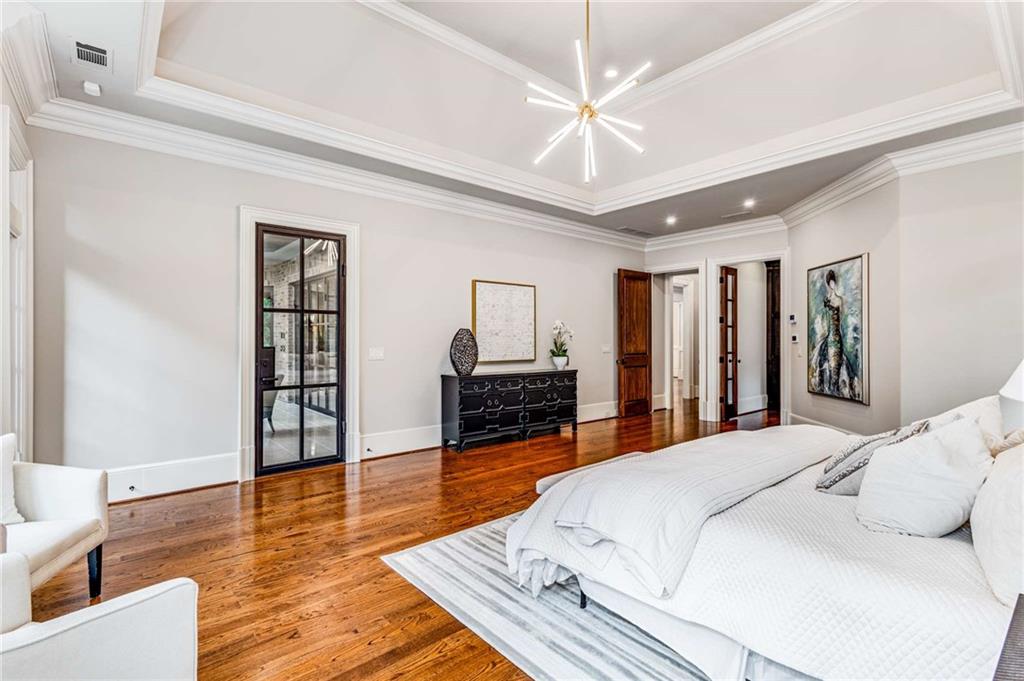 56 Mt Paran Road Northwest Atlanta, GA 30327 - Photo 19 of 52 a bedroom with a large bed a flat tv screen and dresser