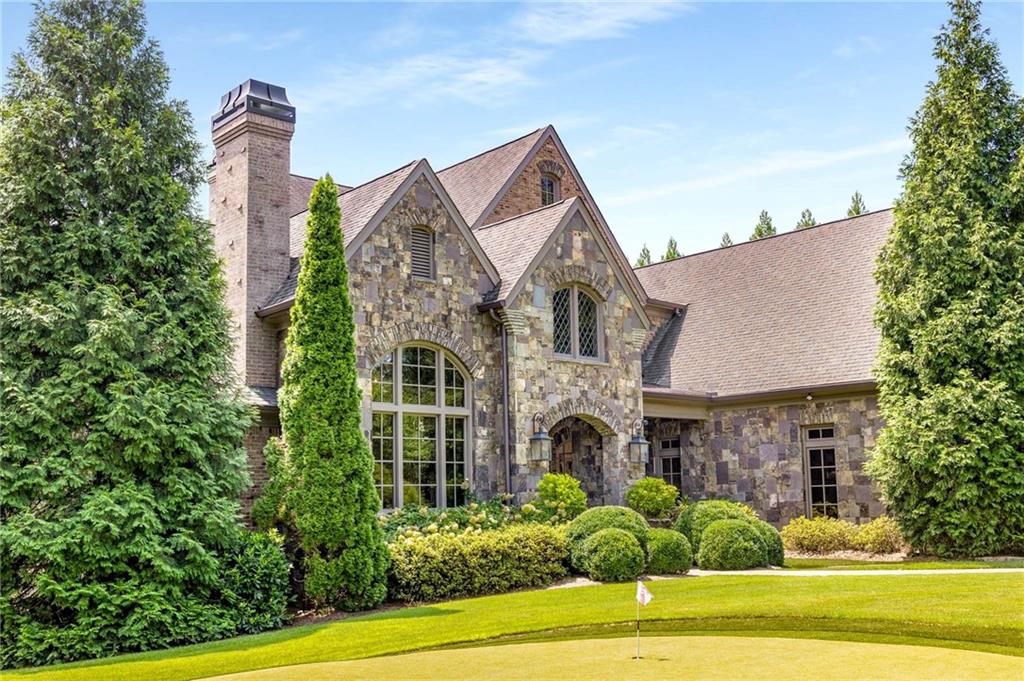 56 Mt Paran Road Northwest Atlanta, GA 30327 - Photo 2 of 52 a front view of a house with a garden and plants