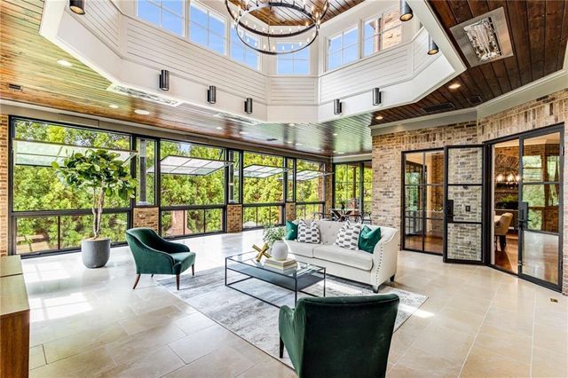 a living room filled with furniture and a potted plant