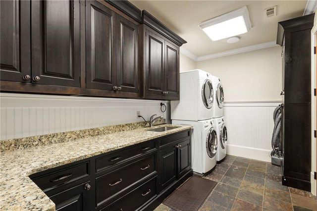 a bathroom with a granite countertop tub sink and mirror