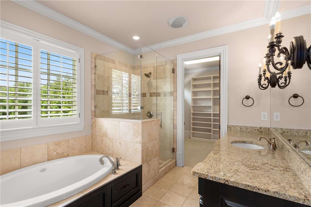 56 Mt Paran Road Northwest Atlanta, GA 30327 - Photo 35 of 52 a bathroom with a granite countertop tub sink and mirror