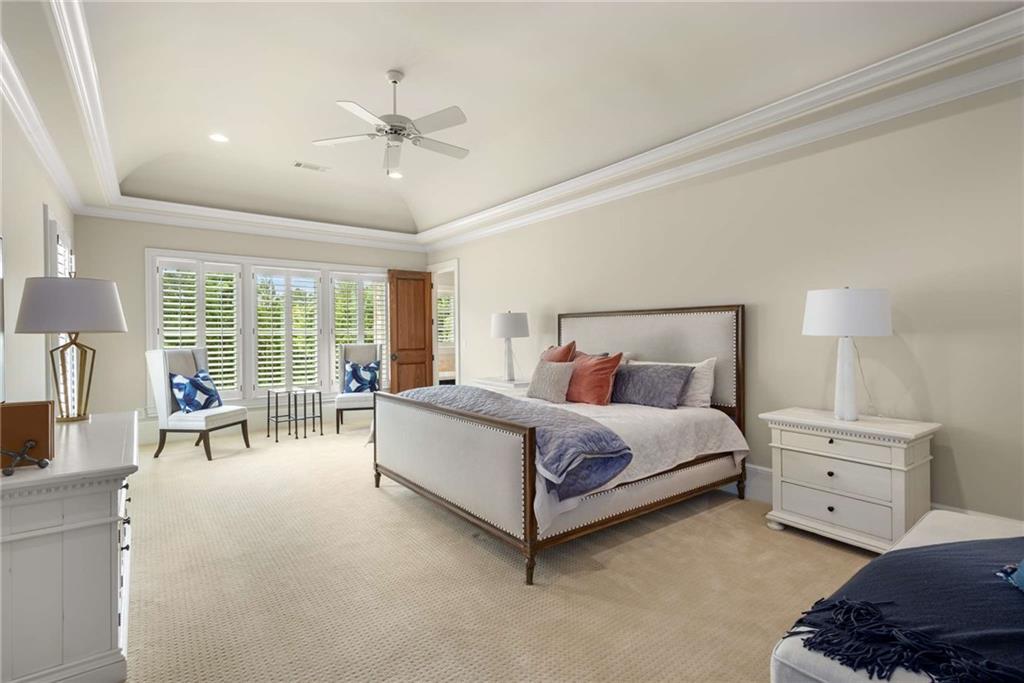 56 Mt Paran Road Northwest Atlanta, GA 30327 - Photo 36 of 52 a spacious bedroom with a bed and a chandelier