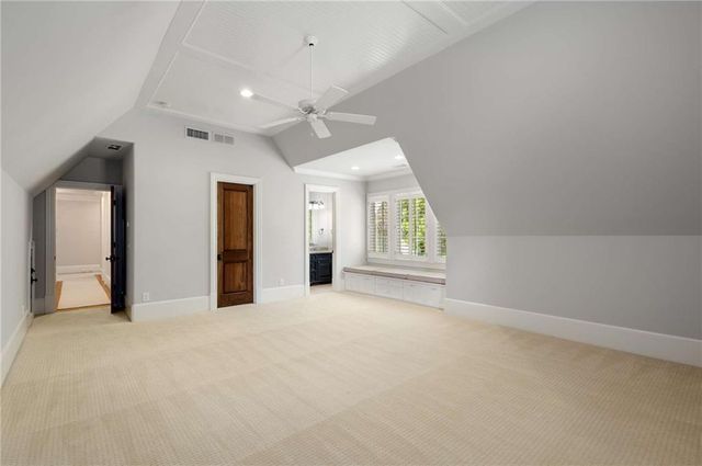 a large kitchen with granite countertop a sink and a wooden floor