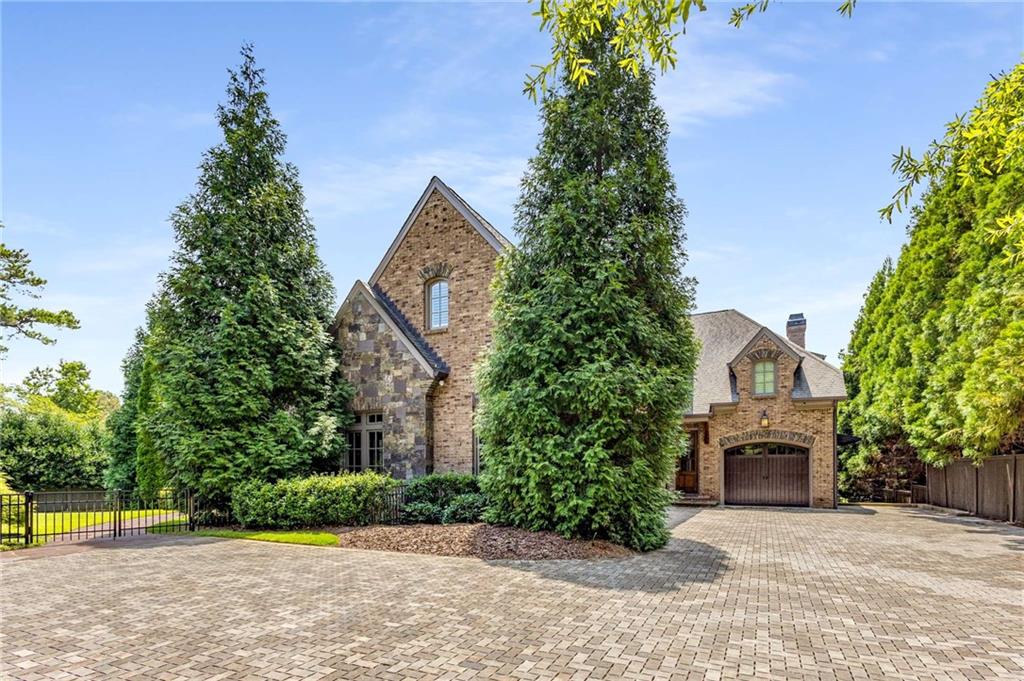 56 Mt Paran Road Northwest Atlanta, GA 30327 - Photo 5 of 52 a front view of a house with a garden