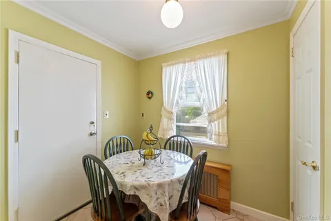 a view of a dining room with furniture and a window