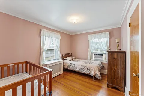 a bedroom with a bed next to a window