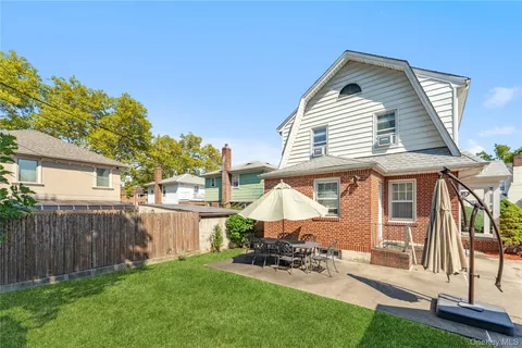 a view of a house with a yard and furniture