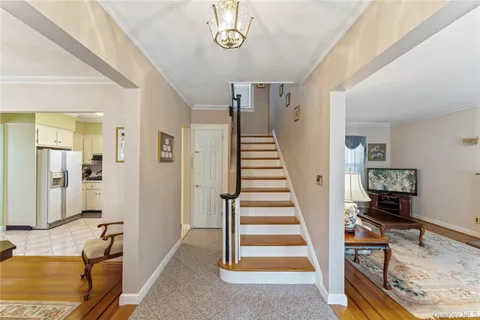 a view of a livingroom with furniture and staircase