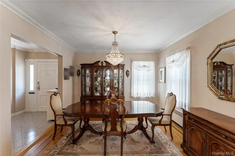 a view of a dining room with furniture and chandelier