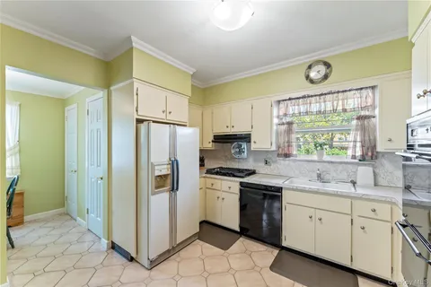 a kitchen with stainless steel appliances a stove a sink and a refrigerator