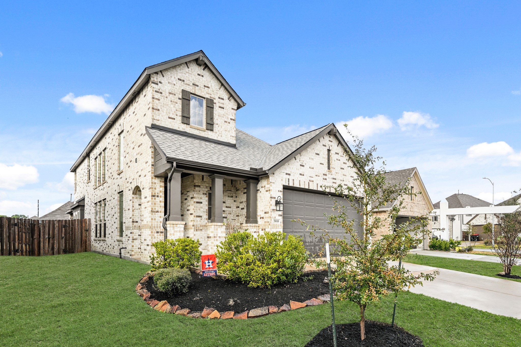 a front view of a house with a yard and seating space