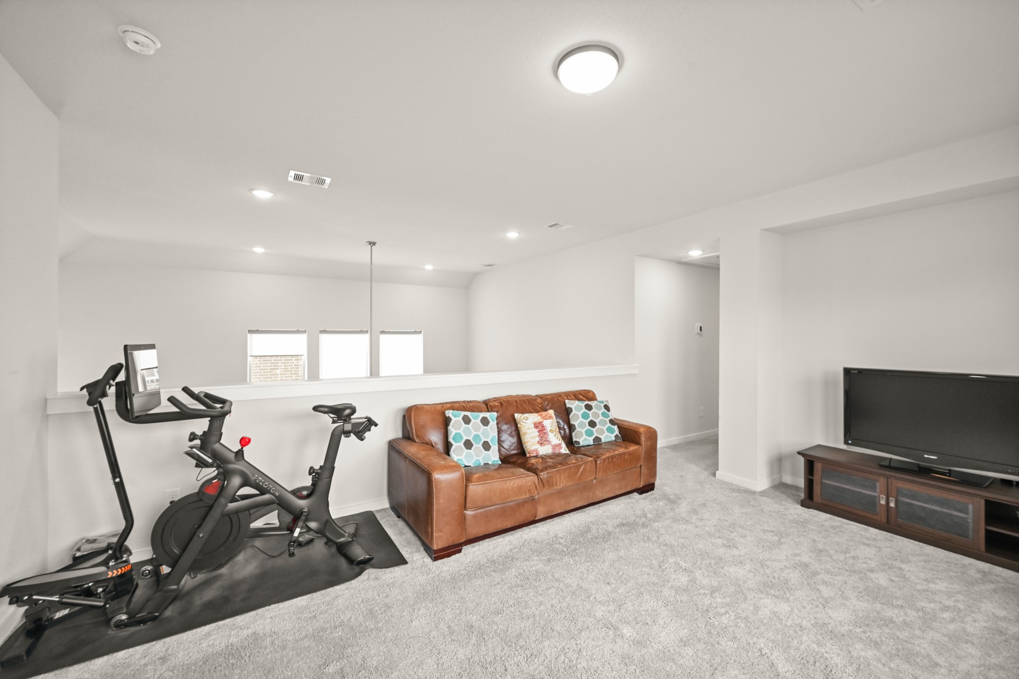 5010 Chestnut Orchard Drive Houston, TX 77066 - Photo 22 of 31 a living room with furniture gym equipment and a flat screen tv