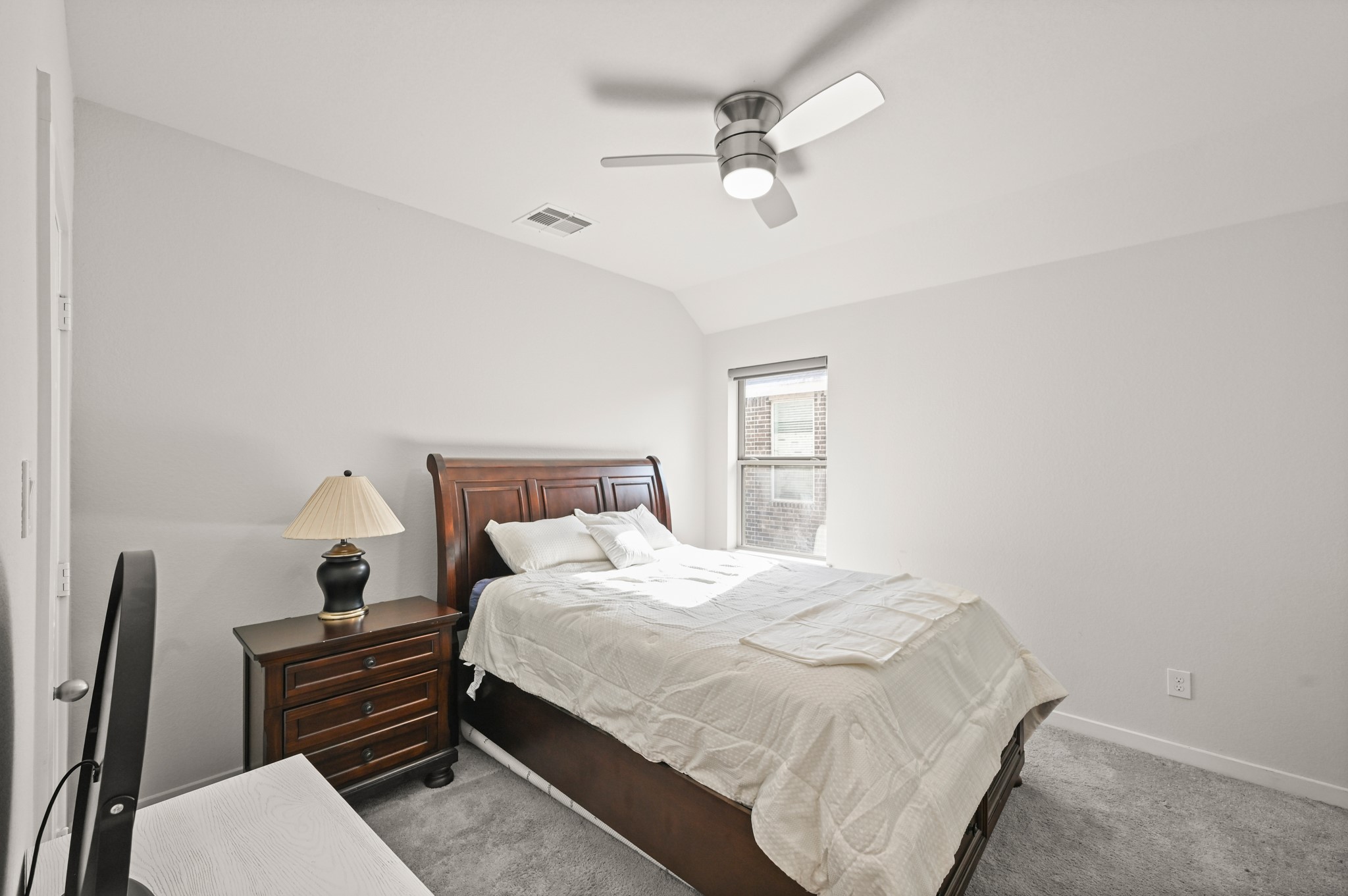 5010 Chestnut Orchard Drive Houston, TX 77066 - Photo 24 of 31 a bedroom with a bed and a chandelier