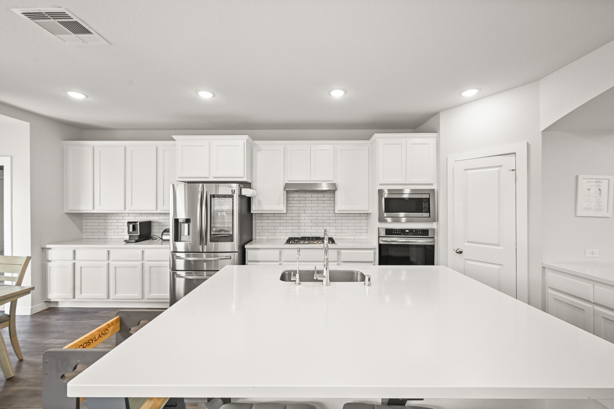 5010 Chestnut Orchard Drive Houston, TX 77066 - Photo 9 of 31 a large kitchen with kitchen island a large counter top space a sink stainless steel appliances and cabinets