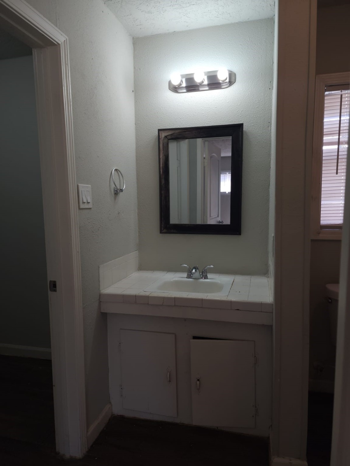 1350 Edwin Street Beaumont, TX 77705 - Photo 16 of 23 a bathroom with a toilet sink and mirror