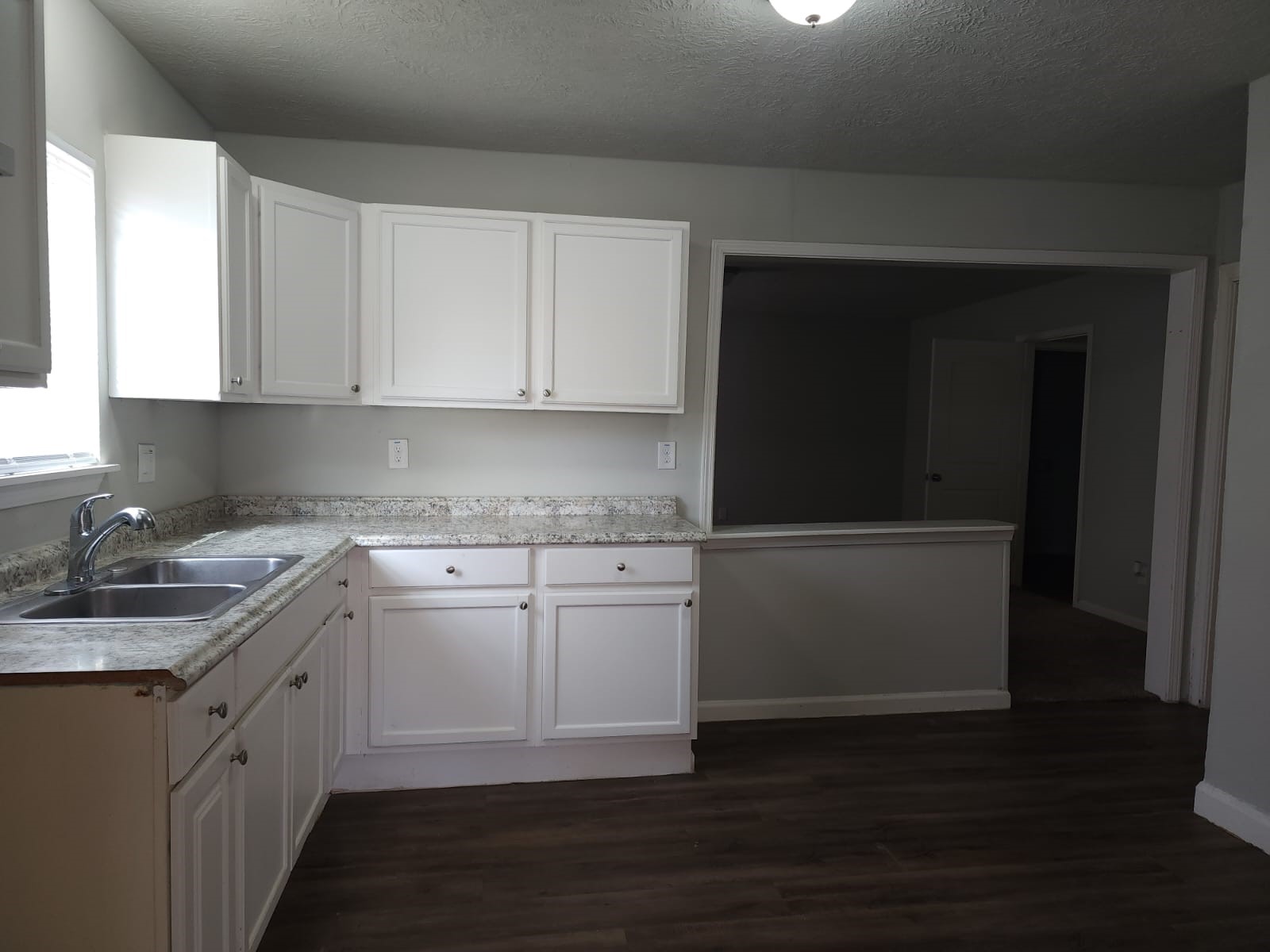 1350 Edwin Street Beaumont, TX 77705 - Photo 5 of 23 a kitchen with granite countertop white cabinets and white appliances