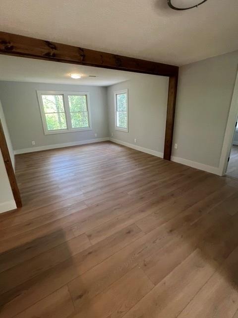 1616 Abe Cove Road Hiawassee, GA 30546 - Photo 10 of 17 an empty room with wooden floor and windows