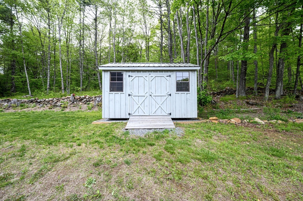 1310 North Brookfield Road Oakham, MA 01068 - Photo 10 of 30 a view of a house with a yard