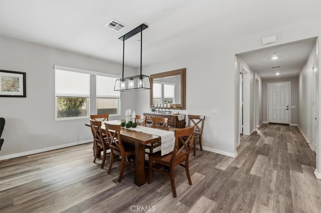 32937 Marin Fields Road Winchester, CA 92596 - Photo 11 of 47 a view of a dining room with furniture window and wooden floor