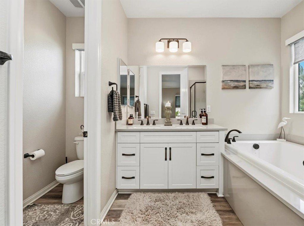32937 Marin Fields Road Winchester, CA 92596 - Photo 21 of 47 a spacious bathroom with a double vanity sink a mirror and a toilet