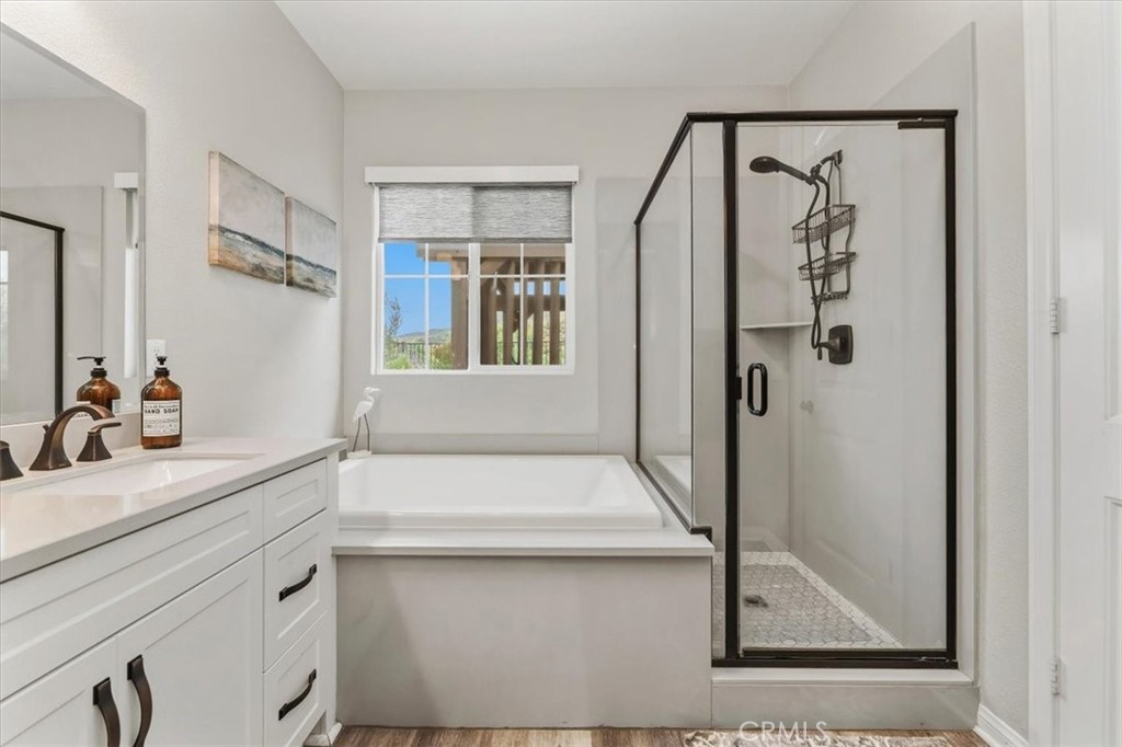 32937 Marin Fields Road Winchester, CA 92596 - Photo 22 of 47 a bathroom with a shower sink and mirror