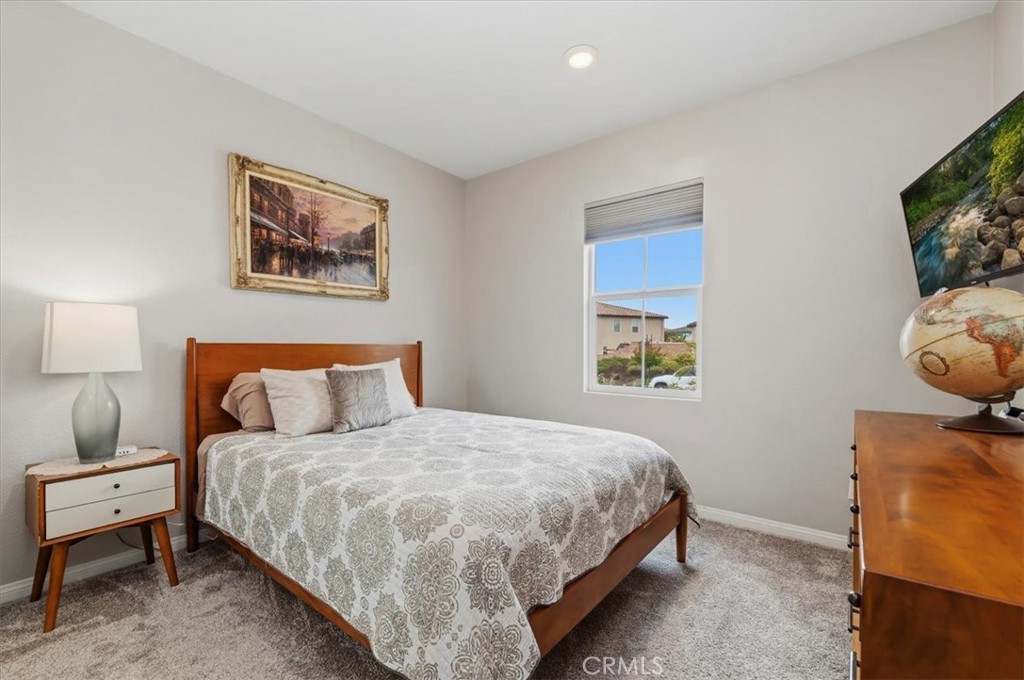 32937 Marin Fields Road Winchester, CA 92596 - Photo 27 of 47 a bedroom with a bed and a flat screen tv