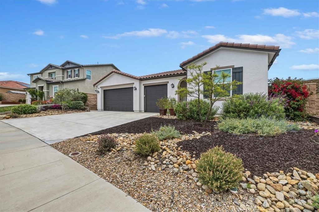 32937 Marin Fields Road Winchester, CA 92596 - Photo 3 of 47 a front view of a house with a garden