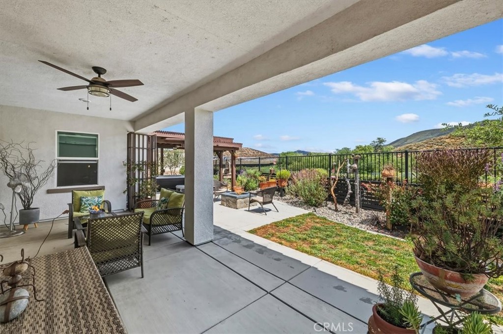 32937 Marin Fields Road Winchester, CA 92596 - Photo 33 of 47 a balcony with furniture and a floor to ceiling window