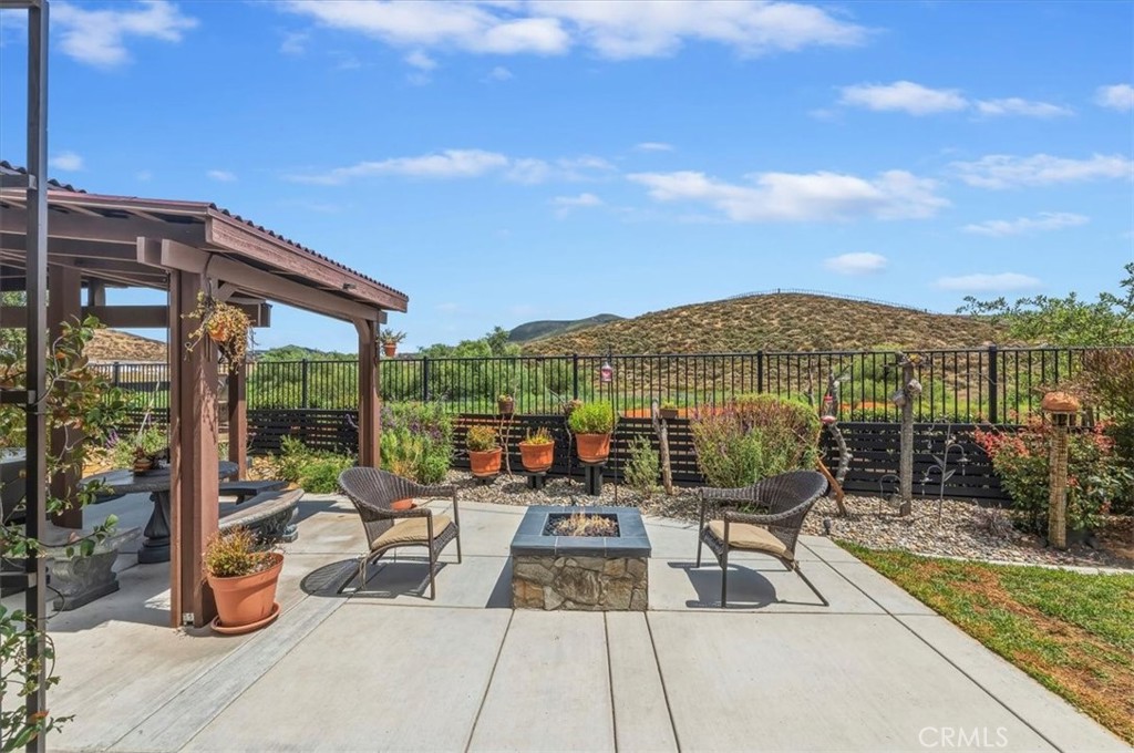 32937 Marin Fields Road Winchester, CA 92596 - Photo 35 of 47 a view of a patio with couches table and chairs and potted plants