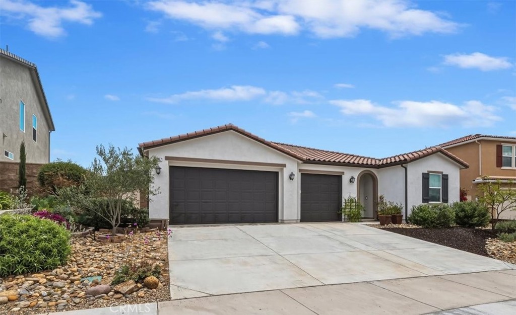 32937 Marin Fields Road Winchester, CA 92596 - Photo 4 of 47 a front view of a house with a yard and garage