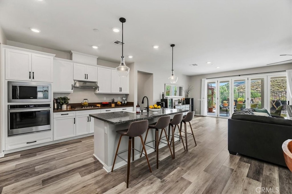 32937 Marin Fields Road Winchester, CA 92596 - Photo 6 of 47 a kitchen with counter top space and wooden floor